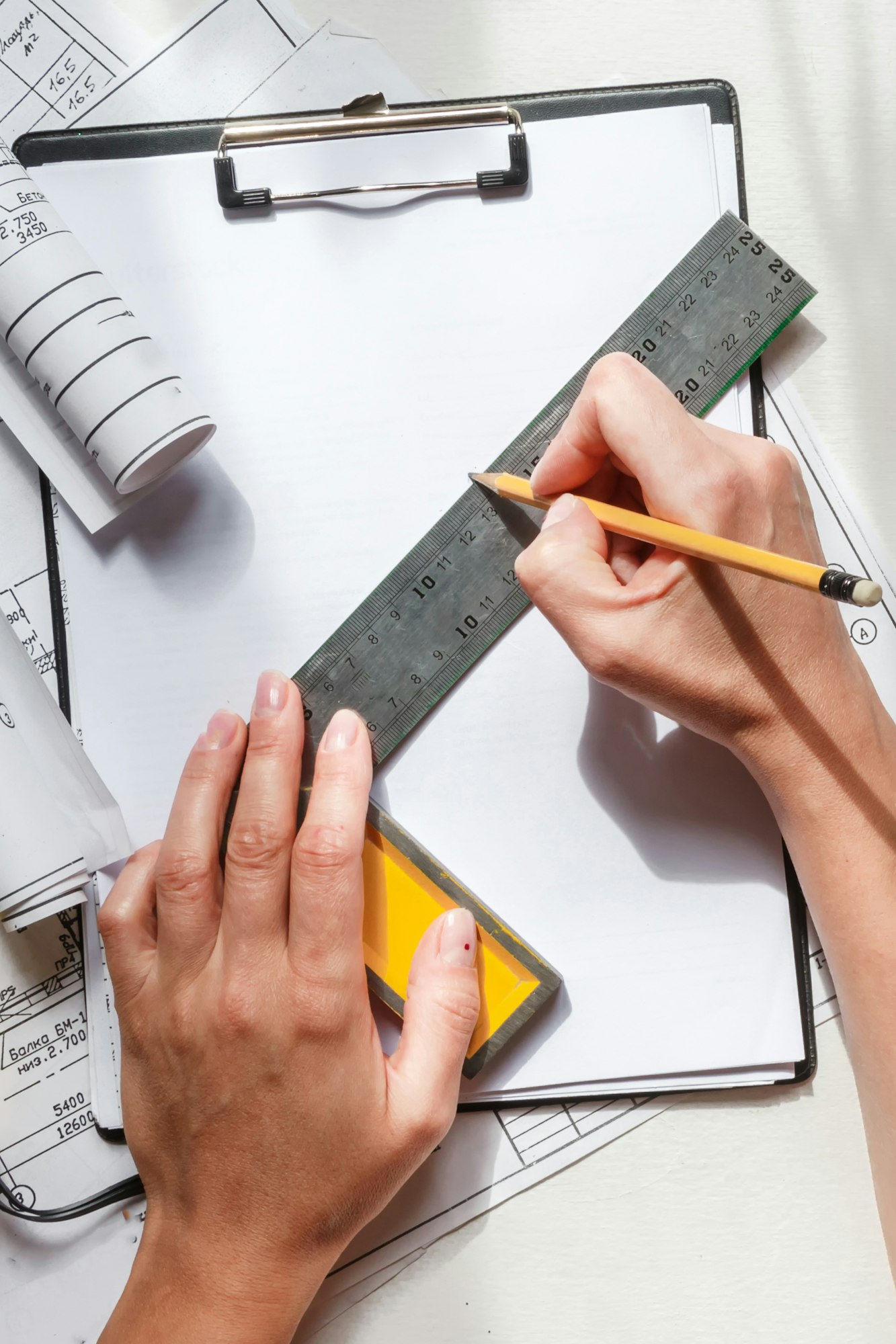 architect design working drawing sketch plans blueprints and making architectural construction model